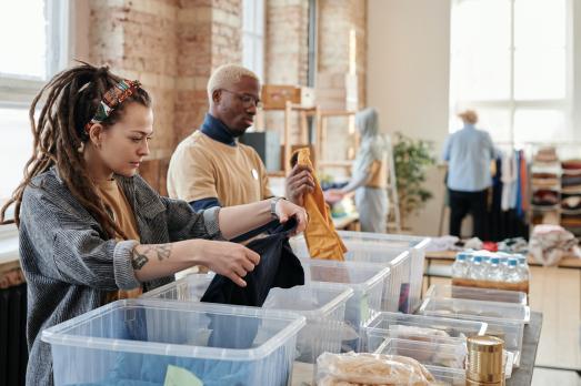 A group of volunteers help out in a food and clothing bank. 