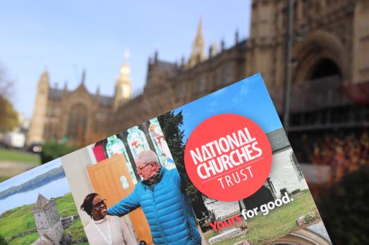 A photograph of the manifesto document in front of Parliament