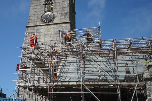 Image of workmen on scaffolding around a church
