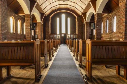 An interior photograph of the aisle inside RCCG Church, Edinburgh