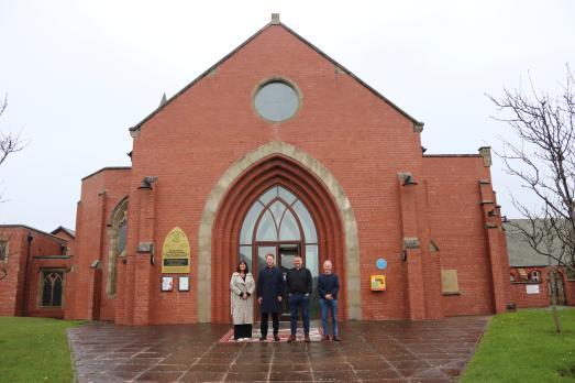 Four people stand outside the front of St Stephen on the Cliffs Church in Blackpool