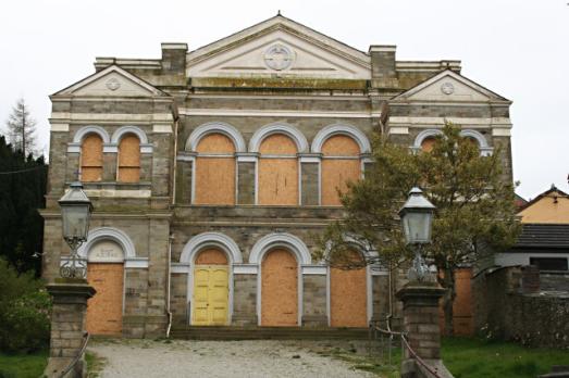 An image of a boarded up church