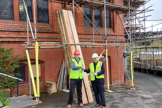 National Churches Trust staff with Canon Barry English outside St Illtyd Grade II Listed Church in Dowlais, Wales.