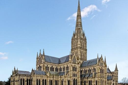 A yellow-coloured cathedral with a very tall spire