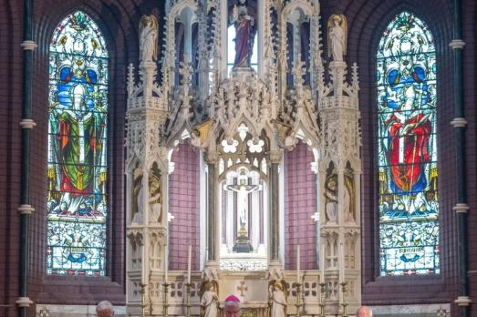 The beautiful altar with stained glass to either side at St Illtyd