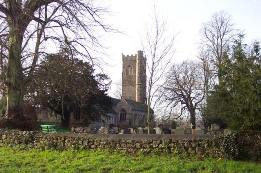 Image of the outside of St Tewdric and surrounding graveyard.