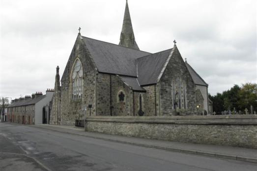 A grey church next to a road