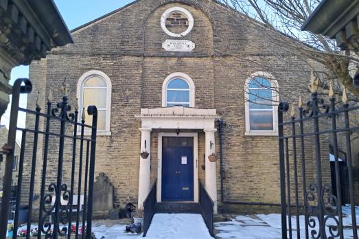 A classical church building with snow outside