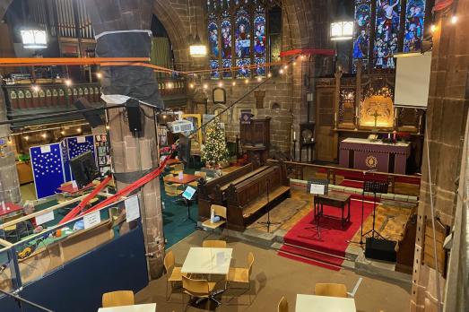 Grand interior of St Peter; an area has been cleared for chairs and tables