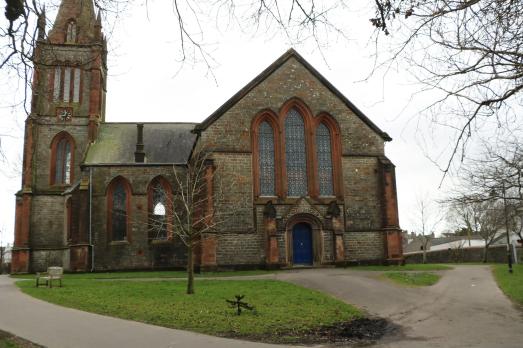 A large Gothic-style church with a tower on the left-hand side of the building. 