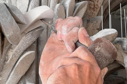Image of hands conducting stone work