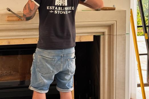 Image of person conducting stone carving fire place