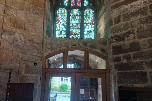 The entrance, taken inside the church. There is a stained glass window above the door.