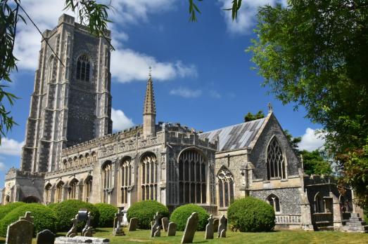 A grand stone church of almost cathedral proportions with a prominent tower on the left-hand side.