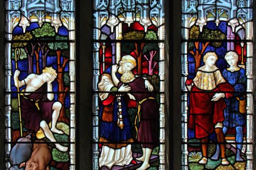 A stained glass window illustrating the story of the Prodigal Son.