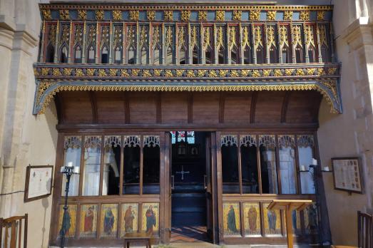 An ornate wooden rood screen.