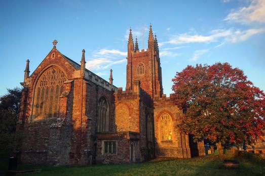 Looking up at the exterior of the church, with a blue sky behind.