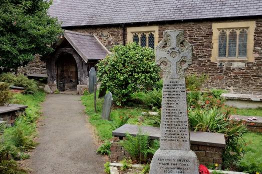 A stone monument with the church visible in the background