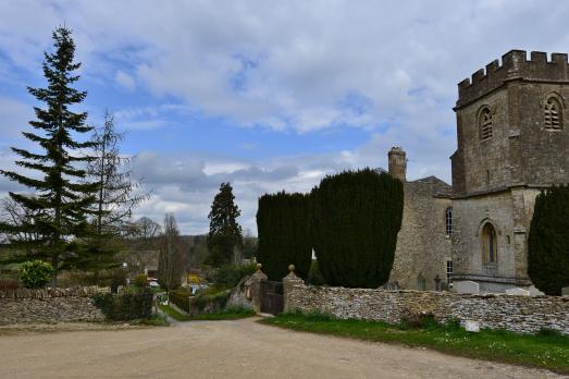 A photo of the church taken from a distance with trees surrounding the building