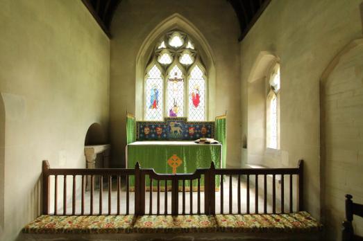 A stained glass window and altar