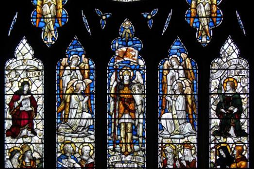 A large colourful stained glass window; the photograph has been taken from up close