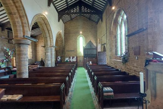 The interior of St Michael: rows of pews face an altar