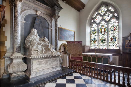 A large stone monument and a stained glass window