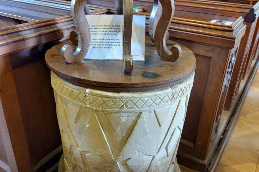 A beautiful  stone font with a wooden cover