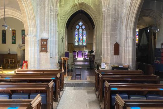 Rows of pews face stone walls and an altar