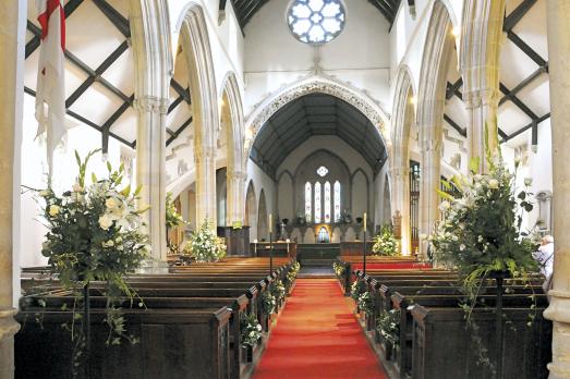 The interior of St Andrew decorated with flowers and foliage