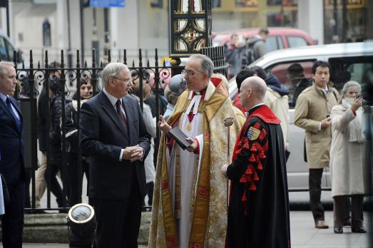 The Duke of Gloucester meets people outside Westminster Abbey; gates are in the background