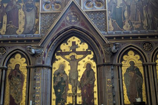 A striking reredos with Christ on a cross in the centre 