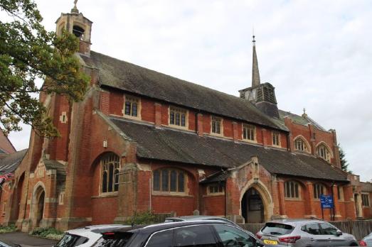 A red brick church with sloped roofs