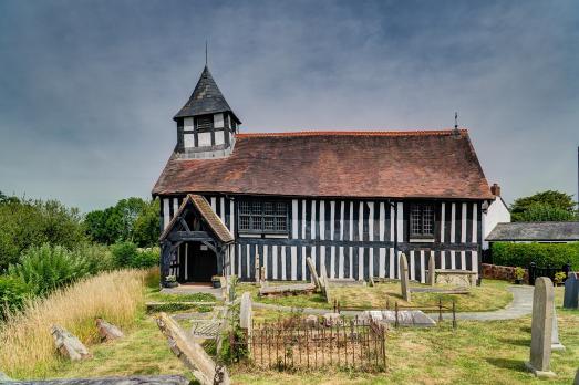 An oak timber panelled early English church photographed on a sunny day