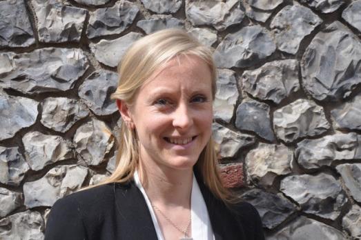 Headshot of Catherine Townsend in front of a stone wall