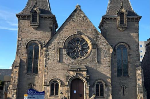 A unique stone church with two large turrets either side of the entrance