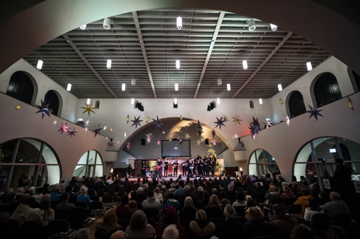 people on the church stage in front of a crowd