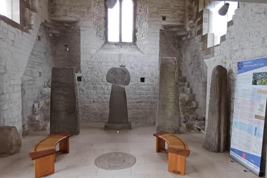 Two wooden benches are set up to view the Celtic standing stones