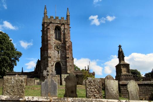 A beautiful photo of St Giles. The church is on a hill with a graveyard visible in front on it. The tower is the most visible part from this elevation.
