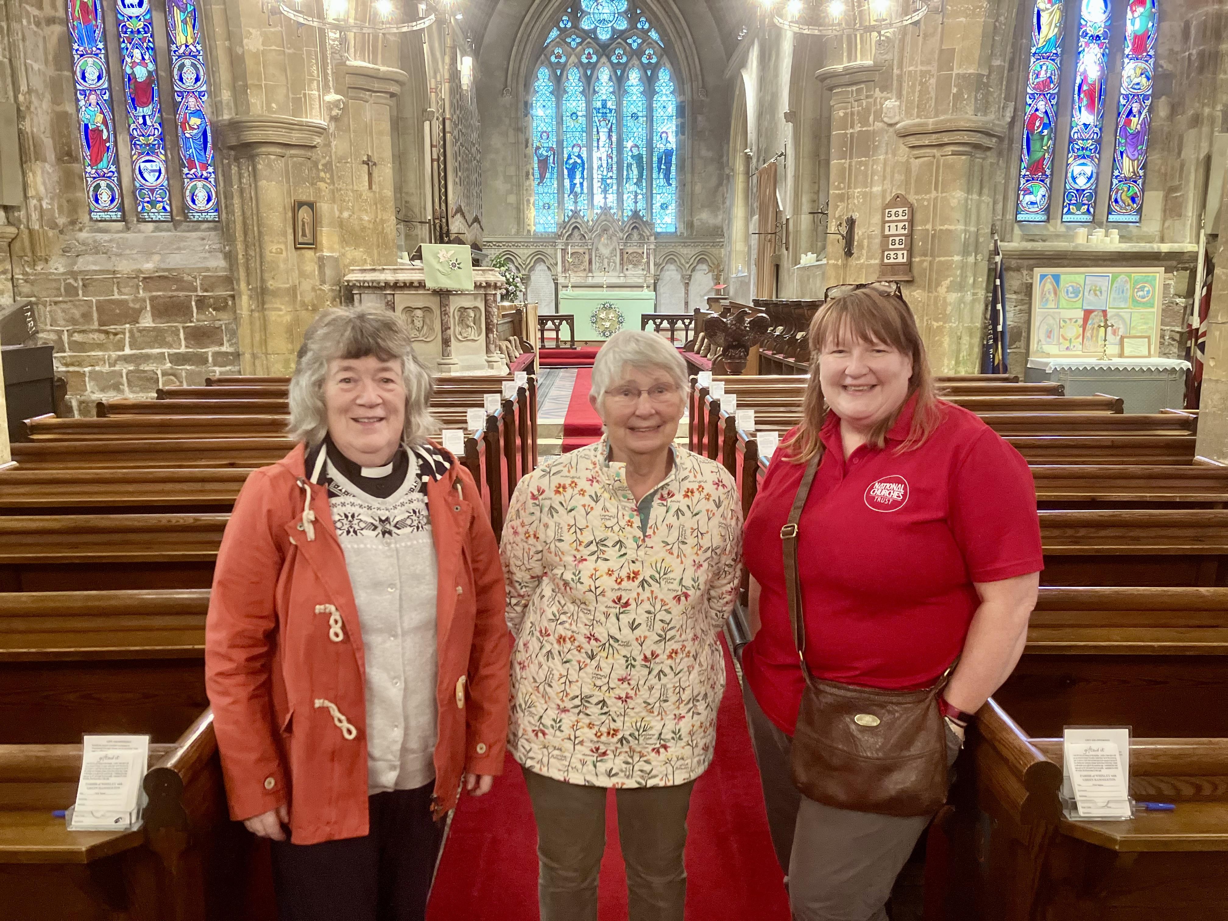 Sarah Crossland, the National Churches Trust's Engagement Manager (right) at the Church of the Ascension in Whixley, Yorkshire, with Revd Joan Roper and Churchwarden and gorgeous cake maker Enid Fisher (centre)