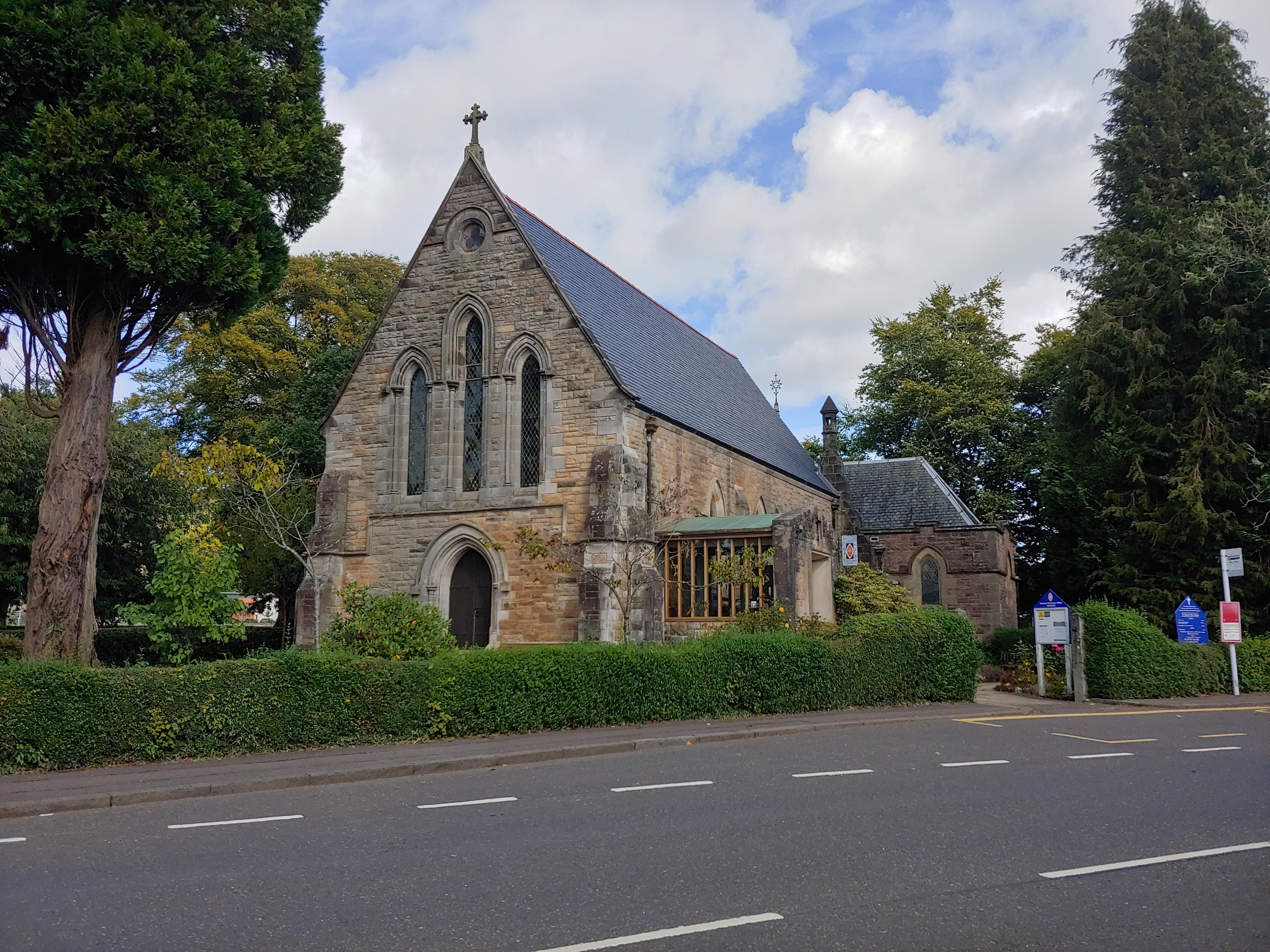 An image of Dollar St James the Great Church with trees to either side.