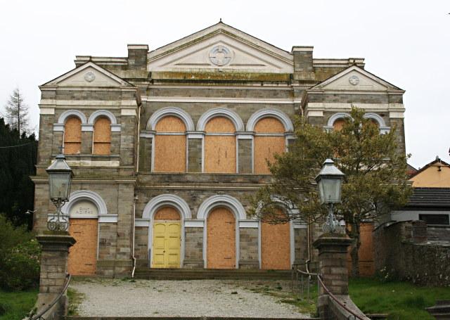 An image of a boarded up church