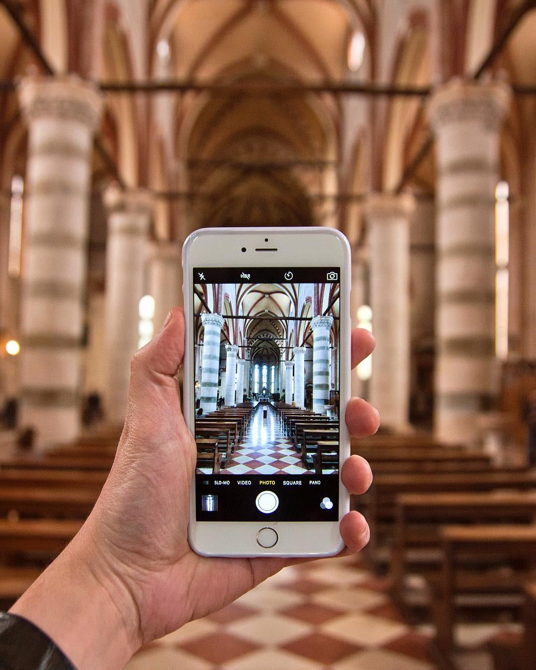 A phone being held up to take a photo inside a church