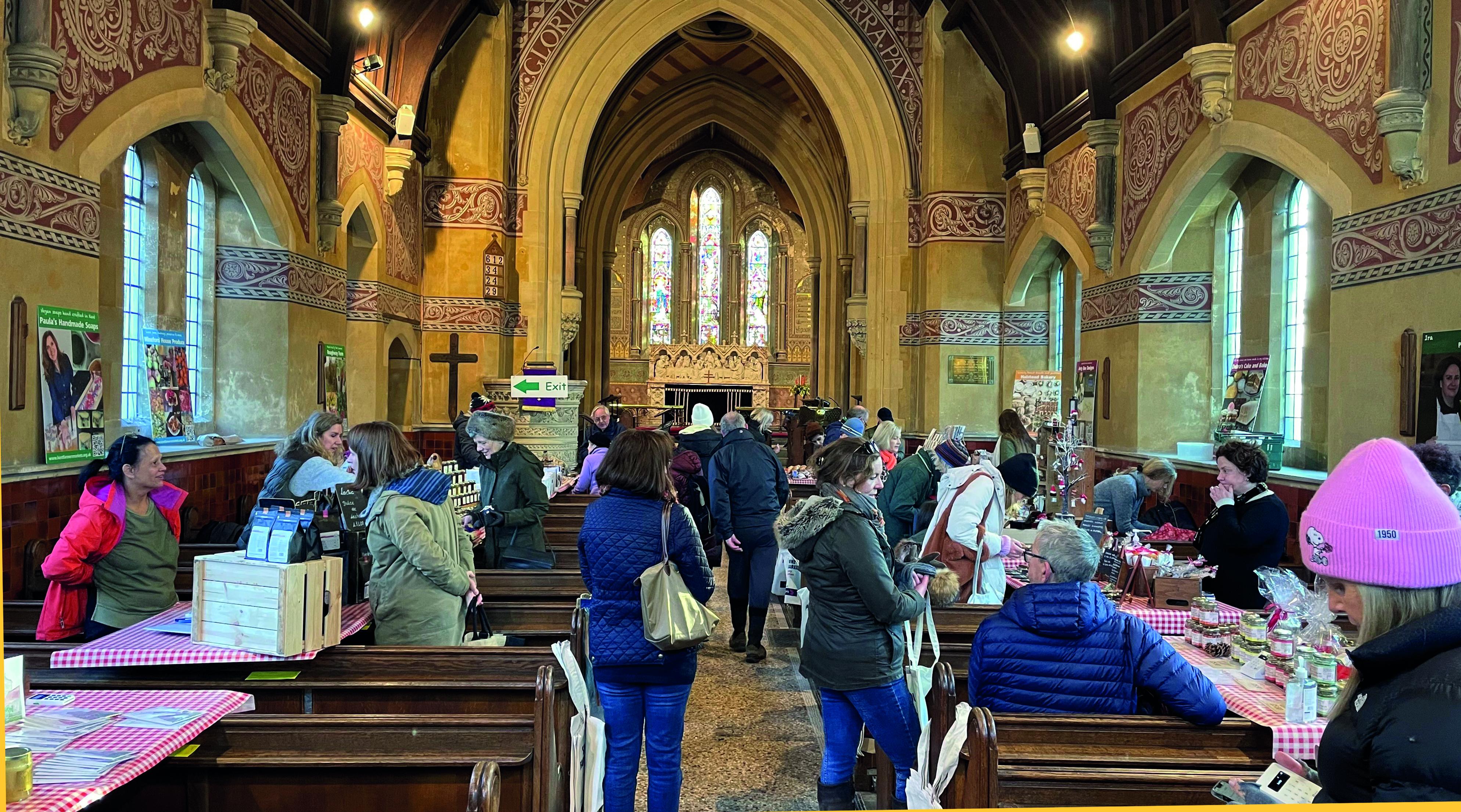 Customers circulate around the stalls in a market