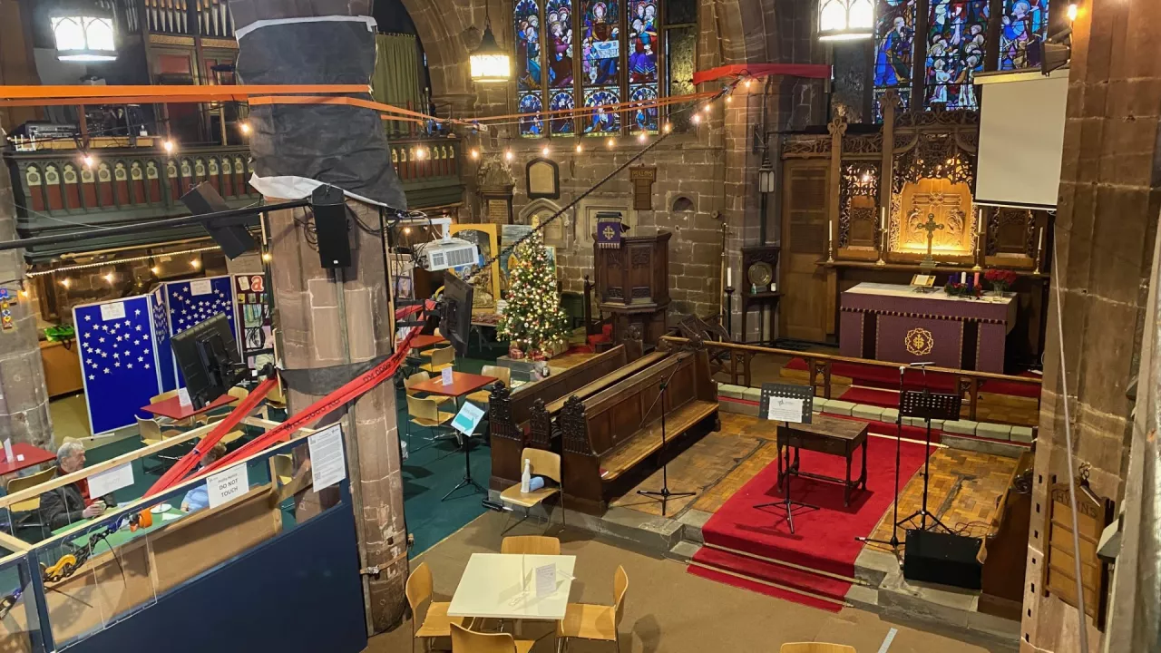 Grand interior of St Peter; an area has been cleared for chairs and tables