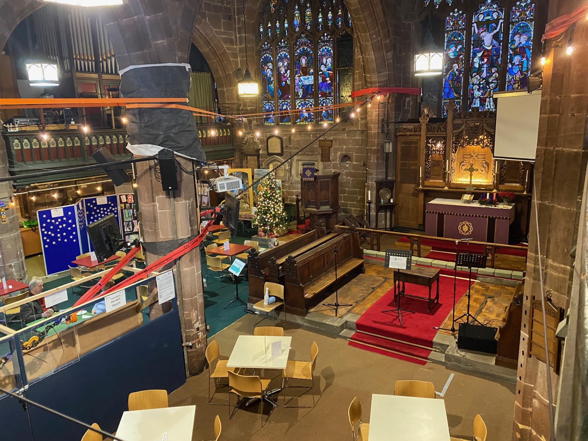 Grand interior of St Peter; an area has been cleared for chairs and tables
