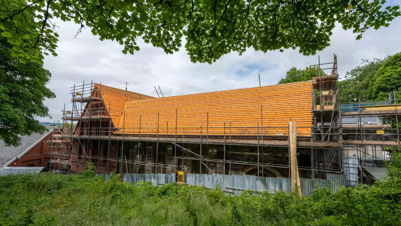 The church roof of Dowlais St Illtyd is visible. It has scaffolding around it as the roof is repaired.