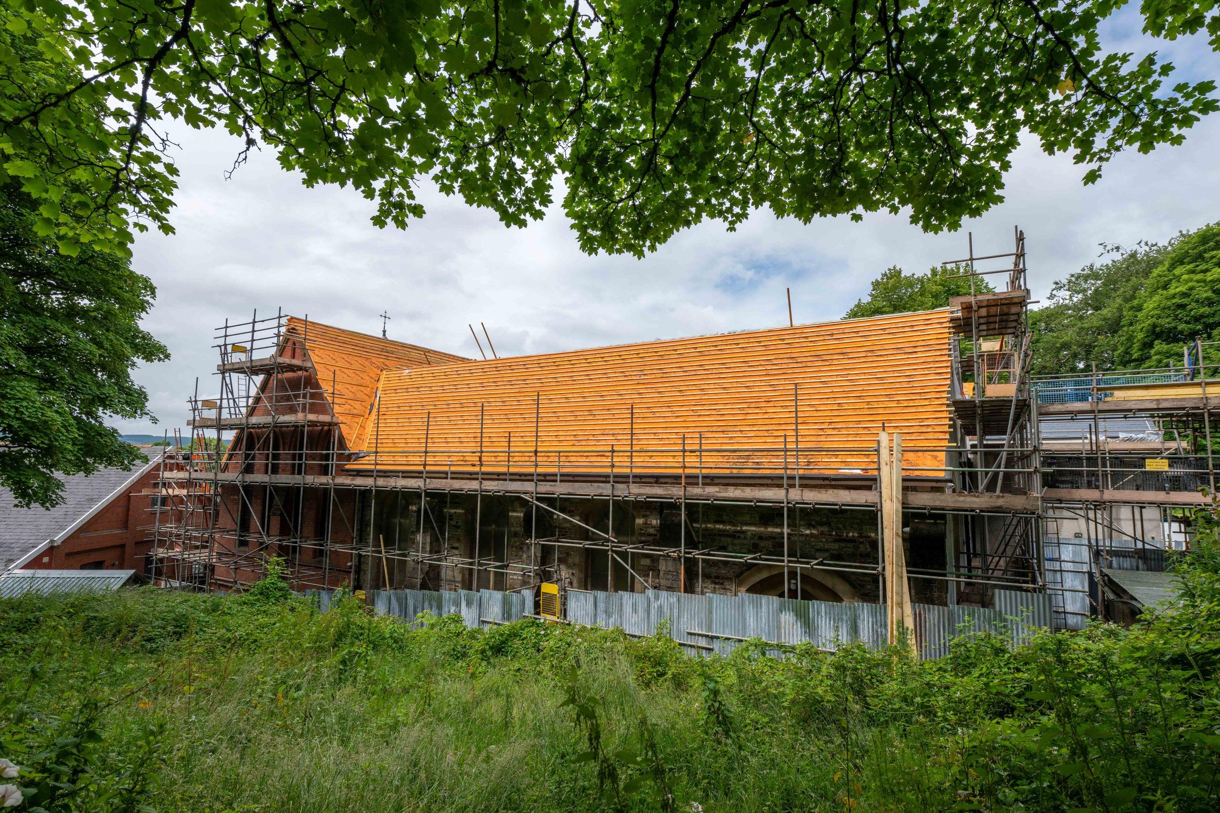 The church roof of Dowlais St Illtyd is visible. It has scaffolding around it as the roof is repaired.