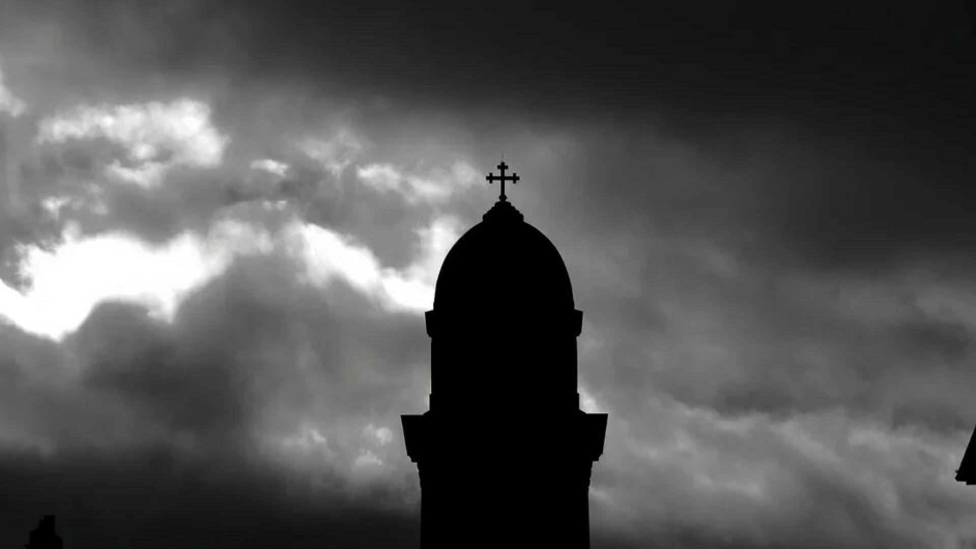 A black and white photo of the tower of Bridgenorth St Mary Magdalene with stormy skies surround it.