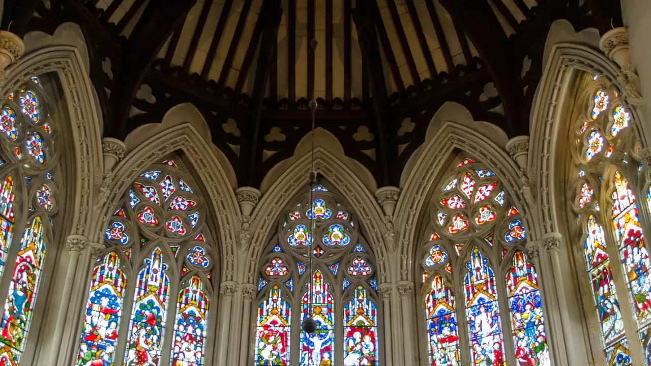 Five arched bright coloured stained glass windows